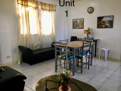 a living room with a table and chairs and a couch at 2bedroom apartment near CONVENTION center in Iloilo City