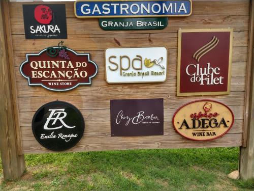 a bunch of signs on a wooden wall at Ap 513 Manacás in Itaipava