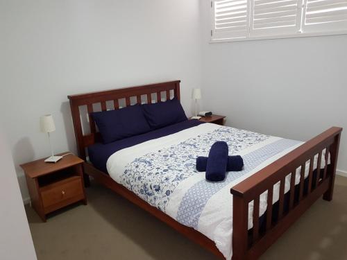 a bedroom with a bed with a blue hat on it at Torquay Timeout in Torquay