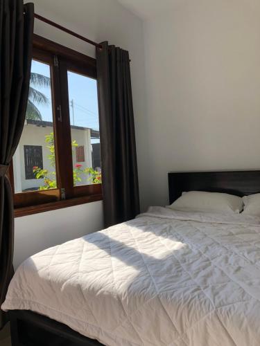 Ένα ή περισσότερα κρεβάτια σε δωμάτιο στο Bí Homestay