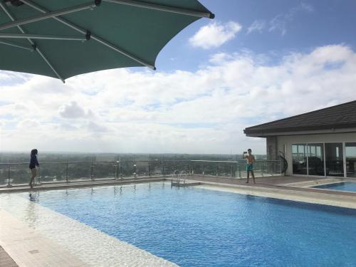 a pool on top of a building with people standing around it at M's Places ORES in Bacolod