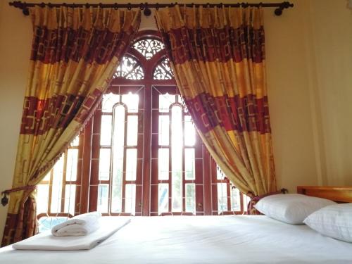a bedroom with a bed and a large window at Viveka Inn Guest and Yala Safari in Tissamaharama