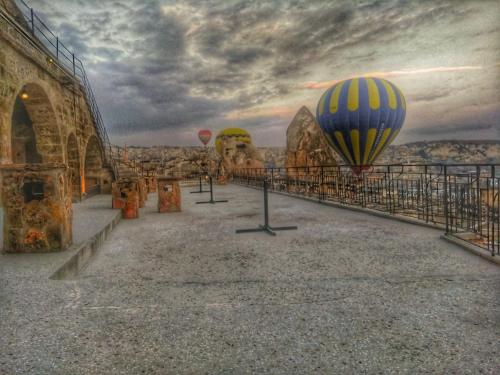 a group of hot air balloons flying over a bridge at Elite Cave Suites in Goreme