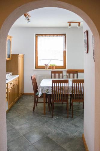a kitchen with a table and chairs and a window at Apartma Smole in Kranjska Gora