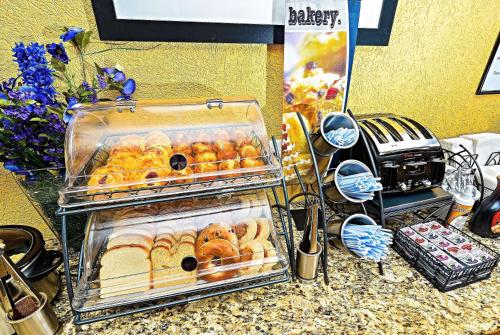 a display of pastries in trays on a counter at Microtel Inn & Suites by Wyndham New Braunfels I-35 in New Braunfels