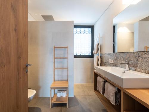 a bathroom with a sink and a mirror at naturApart in Brunico