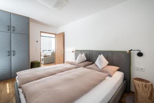 a bedroom with a large bed with pillows on it at naturApart in Brunico