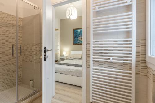 a bathroom with a glass door leading to a bedroom at Sweet Home Bologna in Bologna
