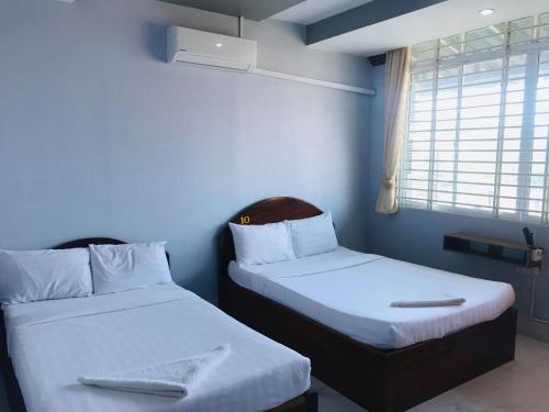 En eller flere senge i et værelse på KampongBay Makeng II Guesthouse