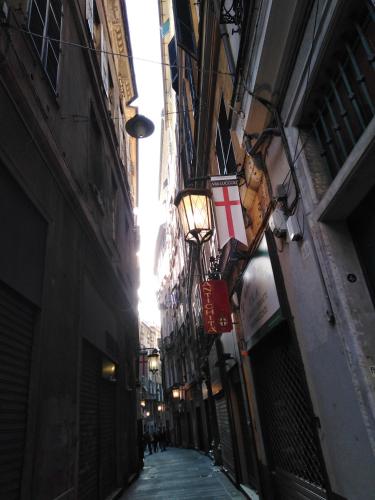 a narrow alley way with buildings and a street light at B&B Amarantha Gothica Genoa in Genova