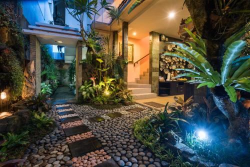 登巴薩的住宿－格里亞屯井紗麗旅館，一座种植了植物的室内花园