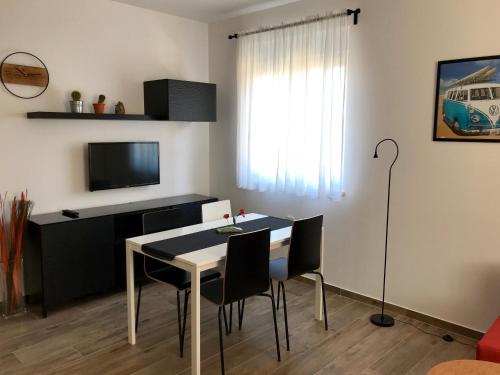 a living room with a table and chairs and a television at Fine & Shine in Pula
