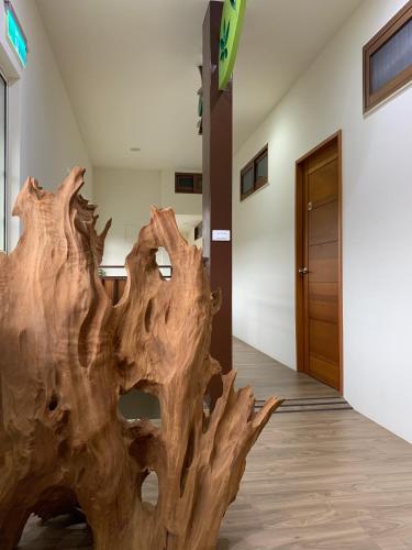 a wooden tree stump in the hallway of a building at Jia's Homestay in Lugu
