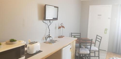 a kitchen with a counter with a tv on the wall at Limassol Motel in Gold Coast