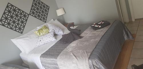 a bed with two pillows on it in a room at Limassol Motel in Gold Coast