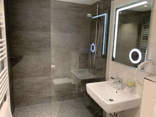 a bathroom with a sink and a shower at Sax Imperial in Dresden