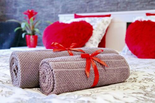 a couple of valentines boxes sitting on a bed at Grey Rooms in Wrocław