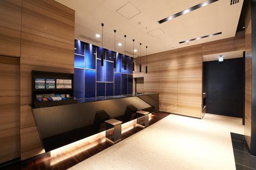 a lobby with a waiting room with blue lighting at Sotetsu Fresa Inn Tokyo Kanda in Tokyo