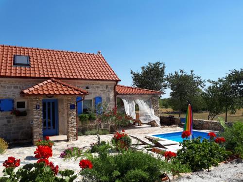 a villa with a swimming pool and a house at Holiday Home Toma in Puljane