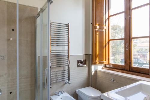 a bathroom with a toilet and a sink and a shower at Favilla Hotel di Charme in Rome