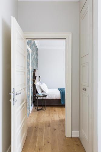 an open door leading to a bedroom with a bed at Favilla Hotel di Charme in Rome