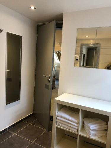 a bathroom with a sink and a mirror at Hotel SPA Au Cheval Blanc in Ribeauvillé