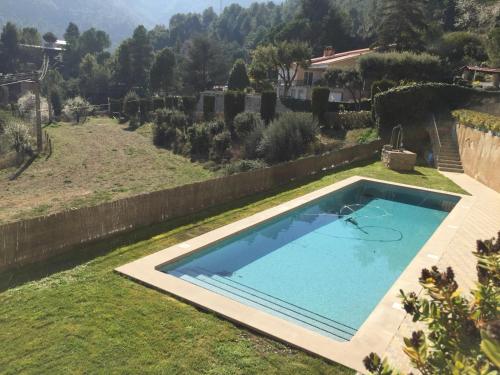 a swimming pool in the yard of a house at Montserrat La Calsina in Monistrol