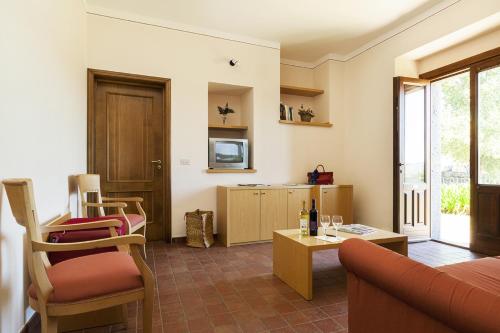 a living room with a couch and a table at Agriturismo Valle Galfina in Linguaglossa