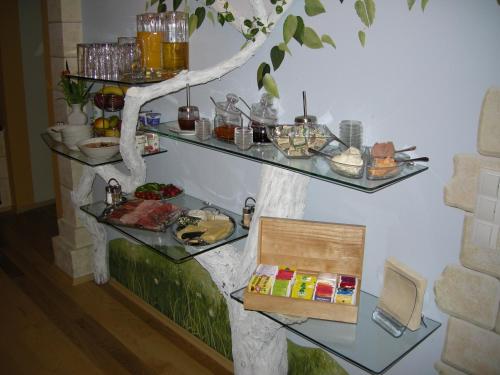 a table with some food on a tree shelf at Pension Arkadenhof in Premstätten