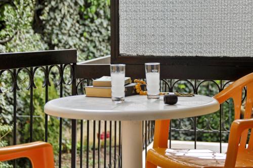 a white table with two glasses on a balcony at Hotel Orpheus in Gouvia