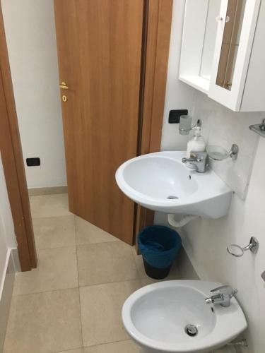 a bathroom with a white sink and a toilet at Palazzo Grigio in Bari