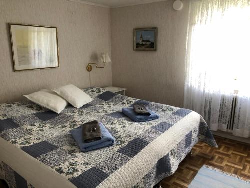 a bedroom with a bed with blue towels on it at Stakaberg Konferens & Gårdshotell in Halmstad