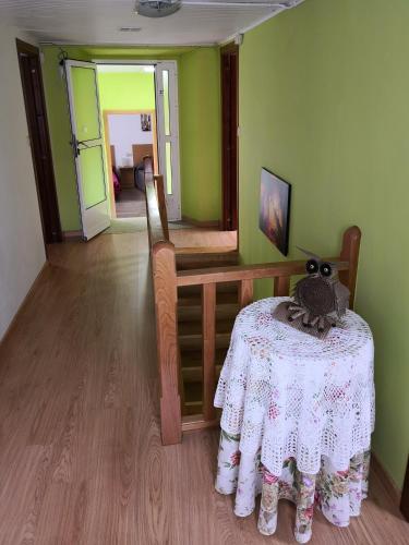 a room with a table with a stuffed animal on it at Casa Carlán in Melide