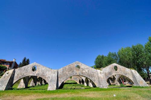 a stone bridge with arches on a field at Hotel Orpheus in Gouvia