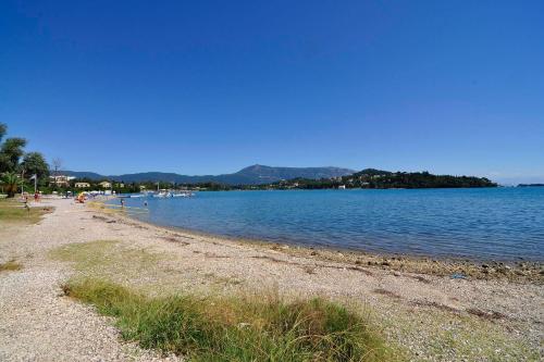 a beach with a large body of water at Hotel Orpheus in Gouvia