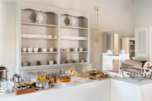 a kitchen with a buffet of food on a counter at Favilla Hotel di Charme in Rome