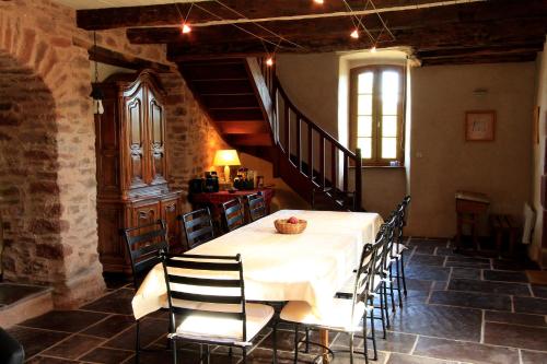 a dining room with a white table and chairs at Domaine Sermet in Calmels-et-le-Viala