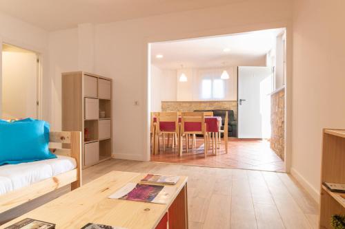 a living room with a couch and a table at La casa azul,una casa en la ciudad. in Logroño