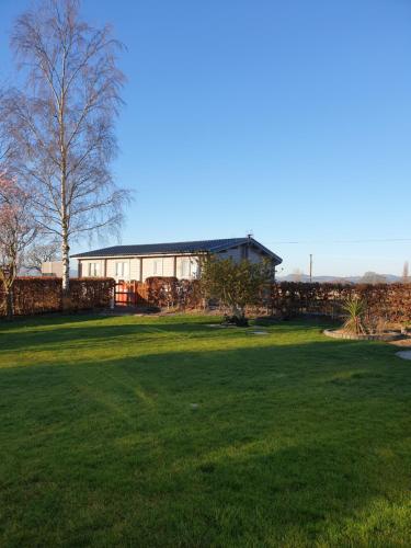 a large yard with a building in the background at Ruth's Retreat Shropshire Countryside Lodge with private hot tub & great views in Shrewsbury