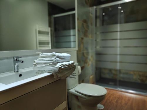 a bathroom with a sink and a toilet and a mirror at Cartagena Centro in Cartagena