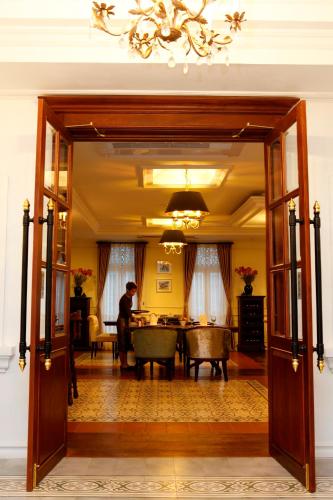 a person sitting at a table in a living room at Dhavara Boutique Hotel in Vientiane