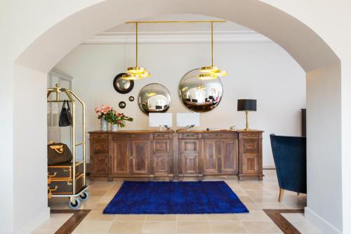 an archway in a room with a table and a blue rug at Favilla Hotel di Charme in Rome