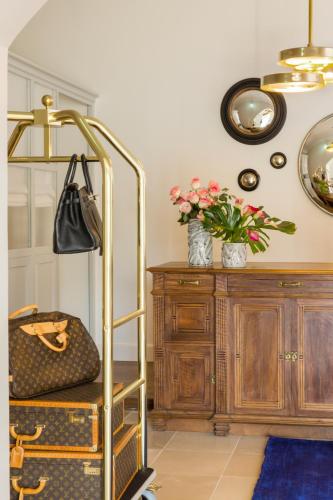 a gold ladder in a room with a table and flowers at Favilla Hotel di Charme in Rome