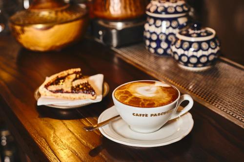 a cup of coffee and a piece of cake on a table at IL VIAGGIATORE VIA INDIPENDENZA B&B in Gaeta