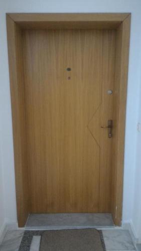 a large wooden door in a room with a rug at Mario in Ohrid