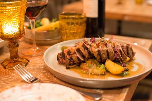 a plate of food on a table with wine glasses at Mercure Oxford Eastgate Hotel in Oxford