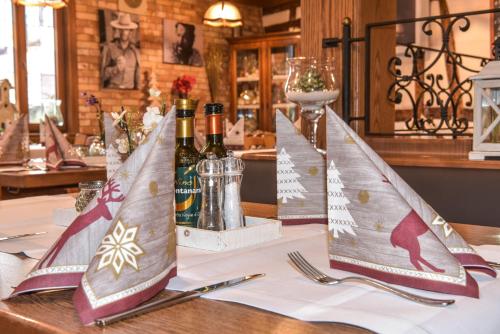 two bottles of wine sitting on a table with napkins at Hotel Ristorante Rostica in Bad Urach
