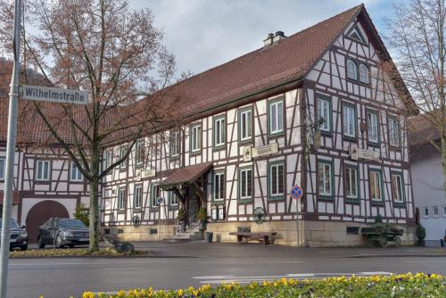 a large wooden building with a brown roof at Hotel Ristorante Rostica in Bad Urach