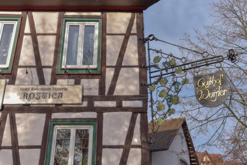 a building with a sign on the side of it at Hotel Ristorante Rostica in Bad Urach