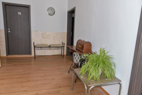 a hallway with a bench and a chair and a door at Hotel Ristorante Rostica in Bad Urach
